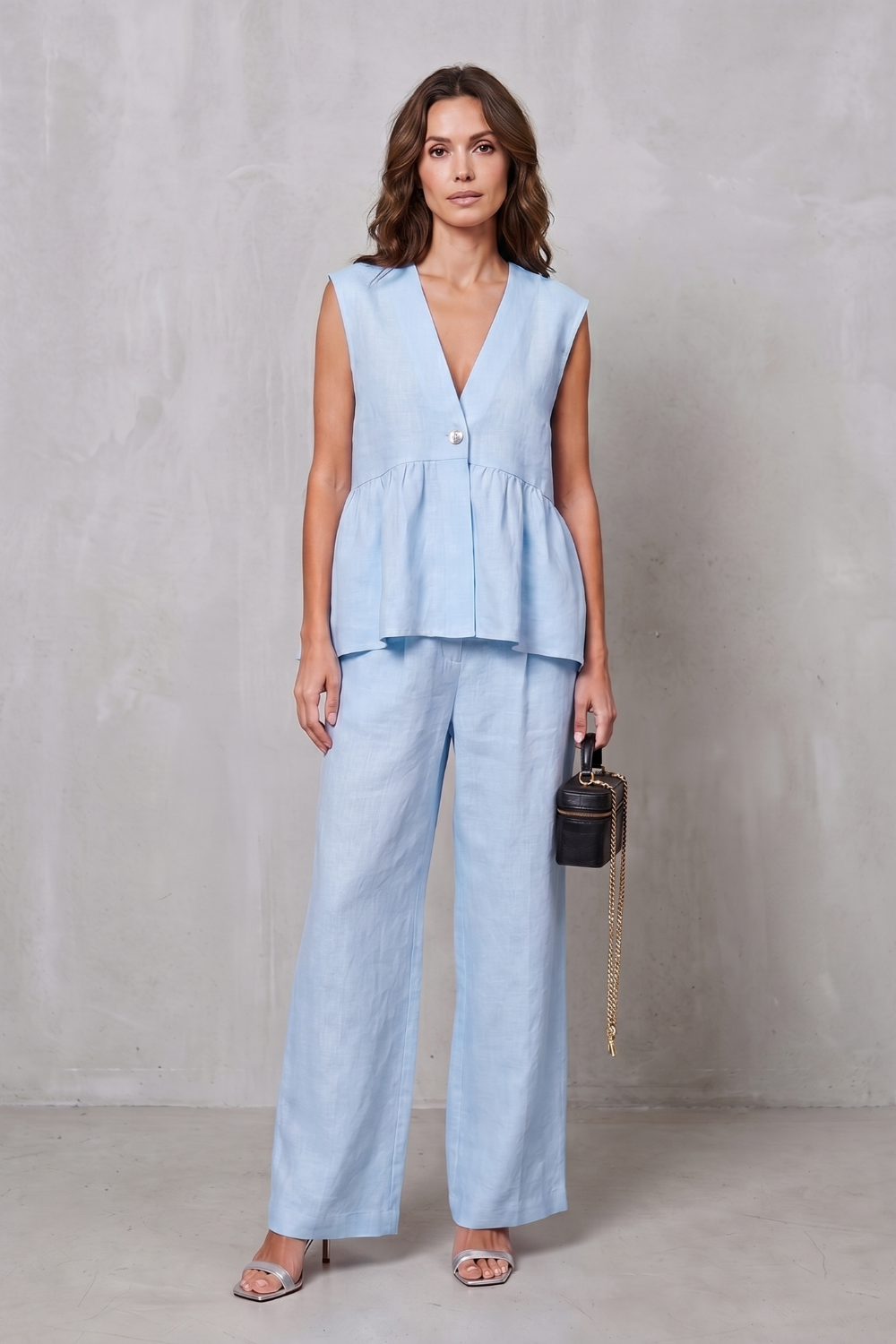 Close-up of the sleeveless armhole and shoulder line on the peplum top