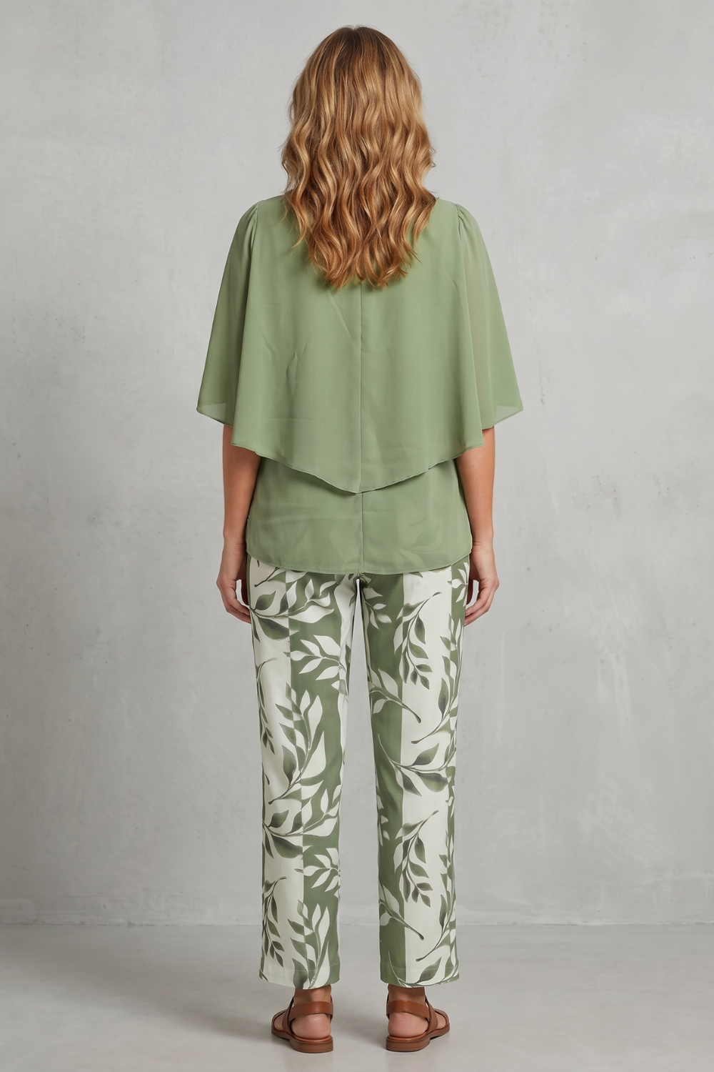 Detail close-up of the botanical print fabric on the wide-leg pants