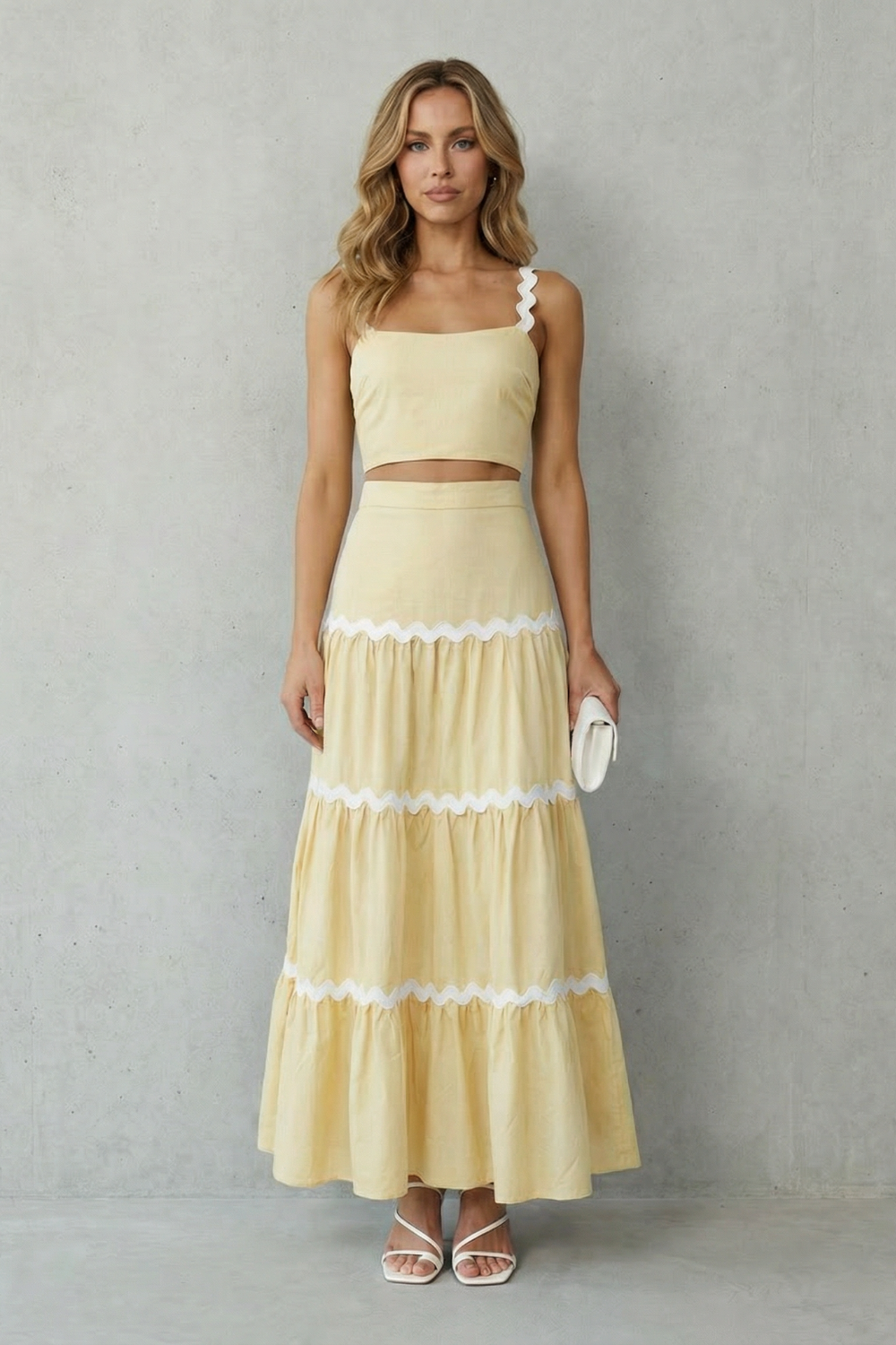 Wave trim skirt set styled with white sandals and a mini clutch