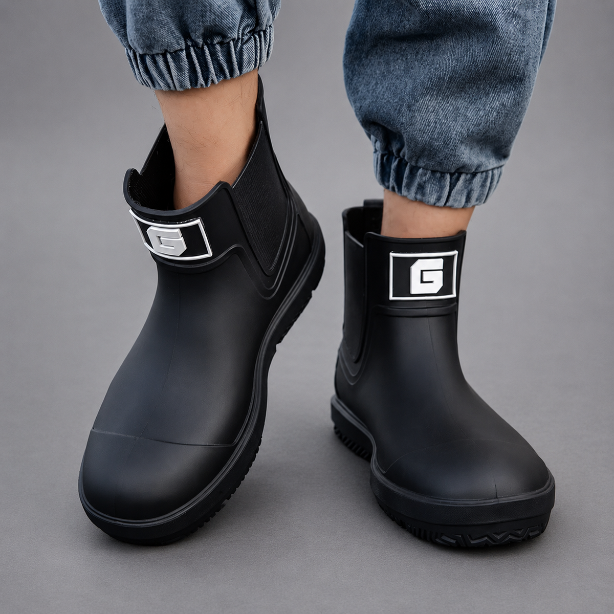Men’s waterproof ankle boots with an easy pull-on design, durable rubber outsole, and slip-resistant tread for wet-weather wear.