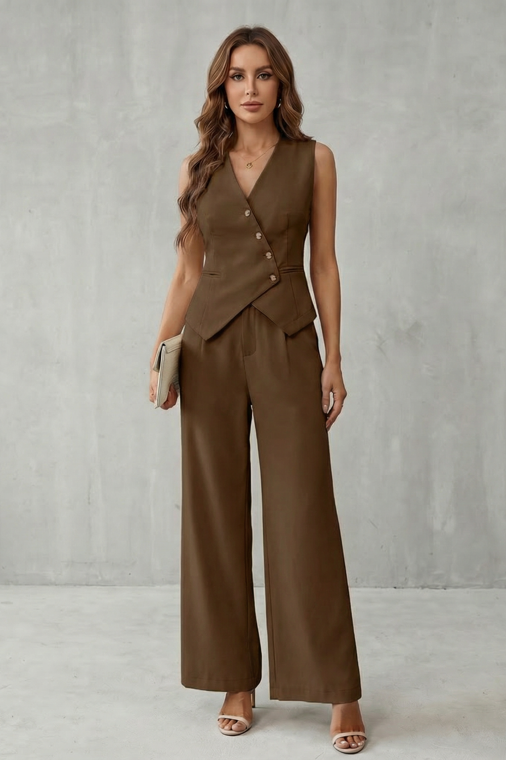 Vest and pants set styled with pointed heels and a structured handbag