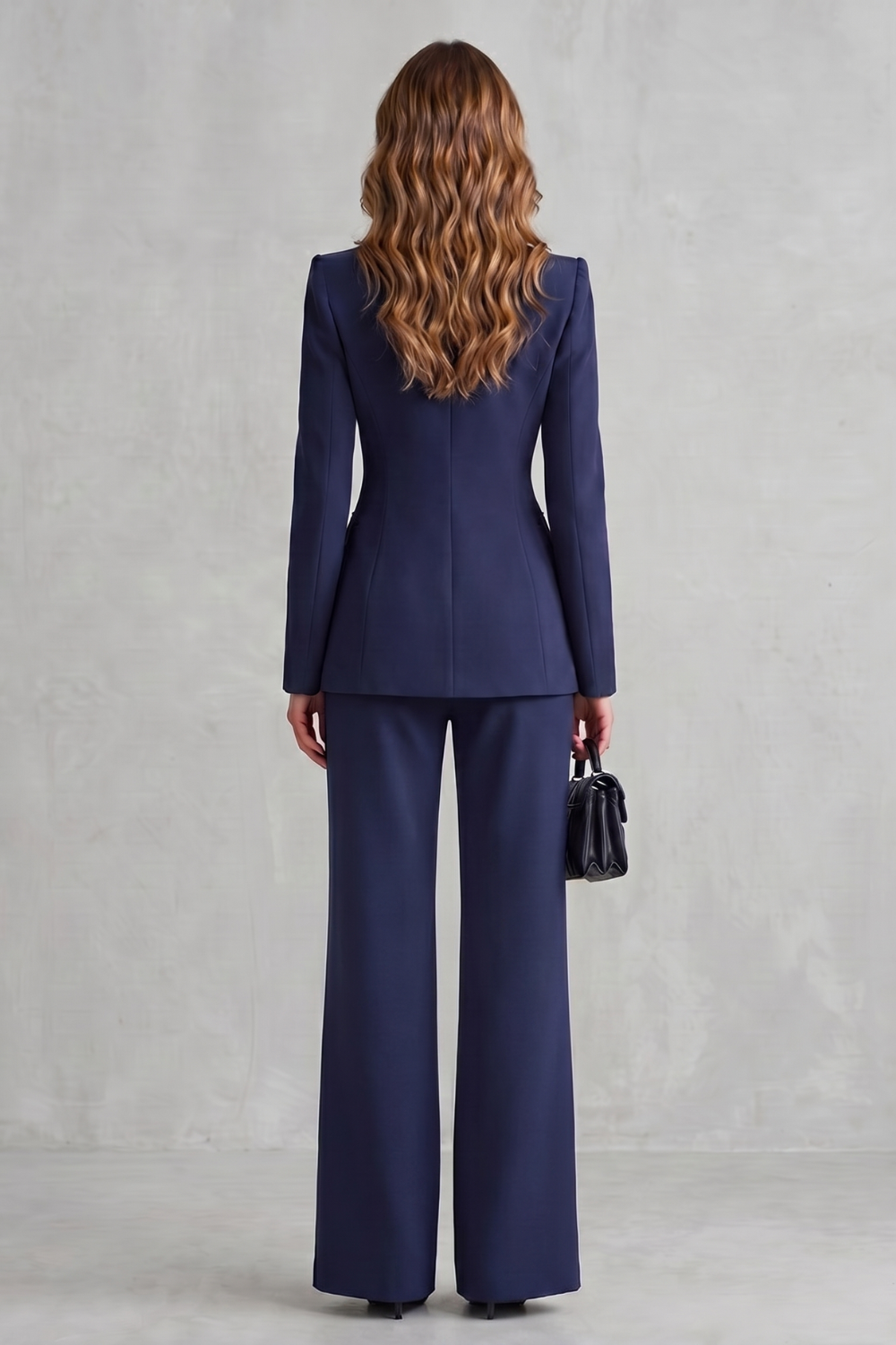 Detail close-up of the single-button closure and stand collar on the blazer