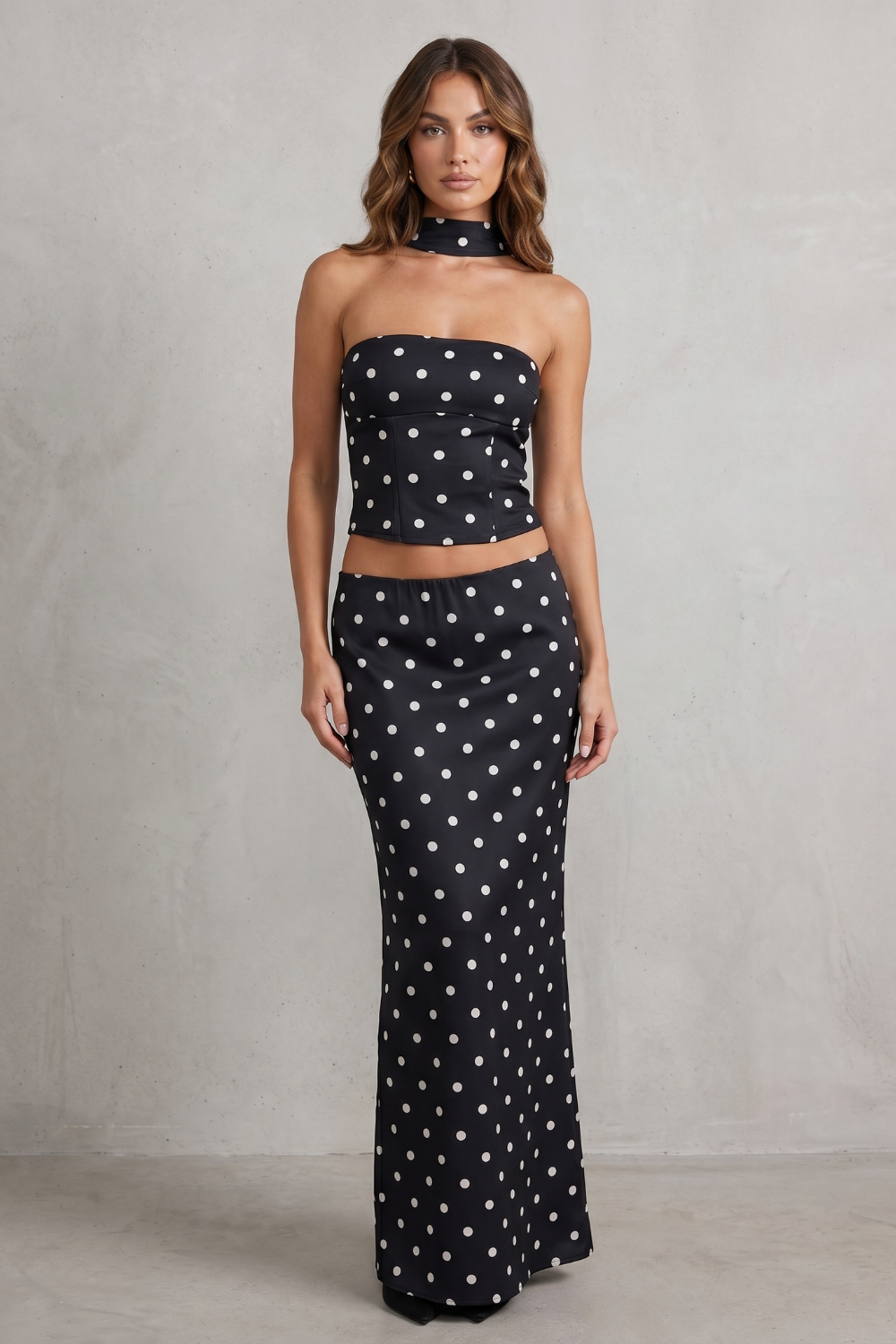 Side view of the polka dot bandeau top and maxi skirt two-piece set