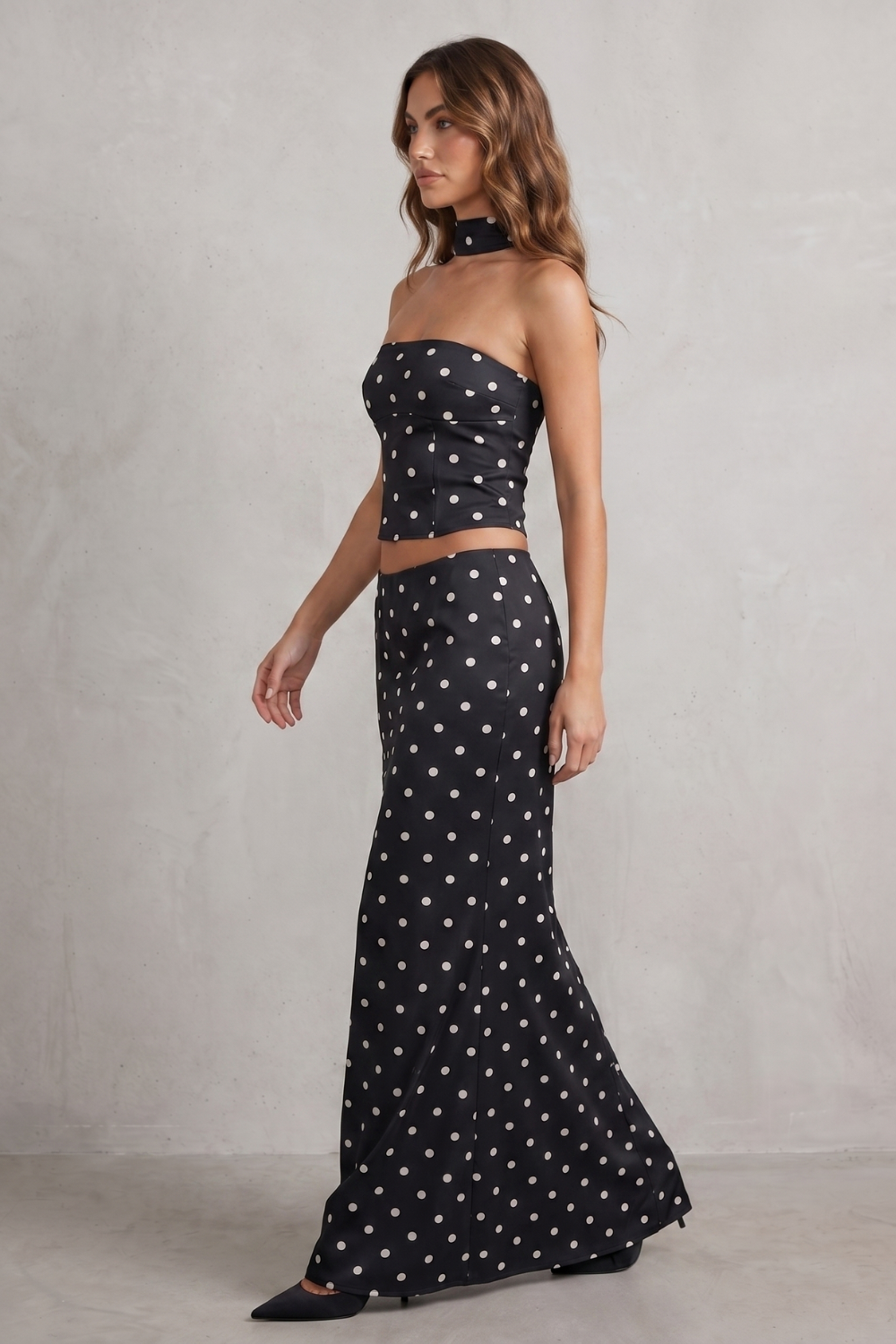 Detail close-up of the polka dot print and strapless bandeau neckline