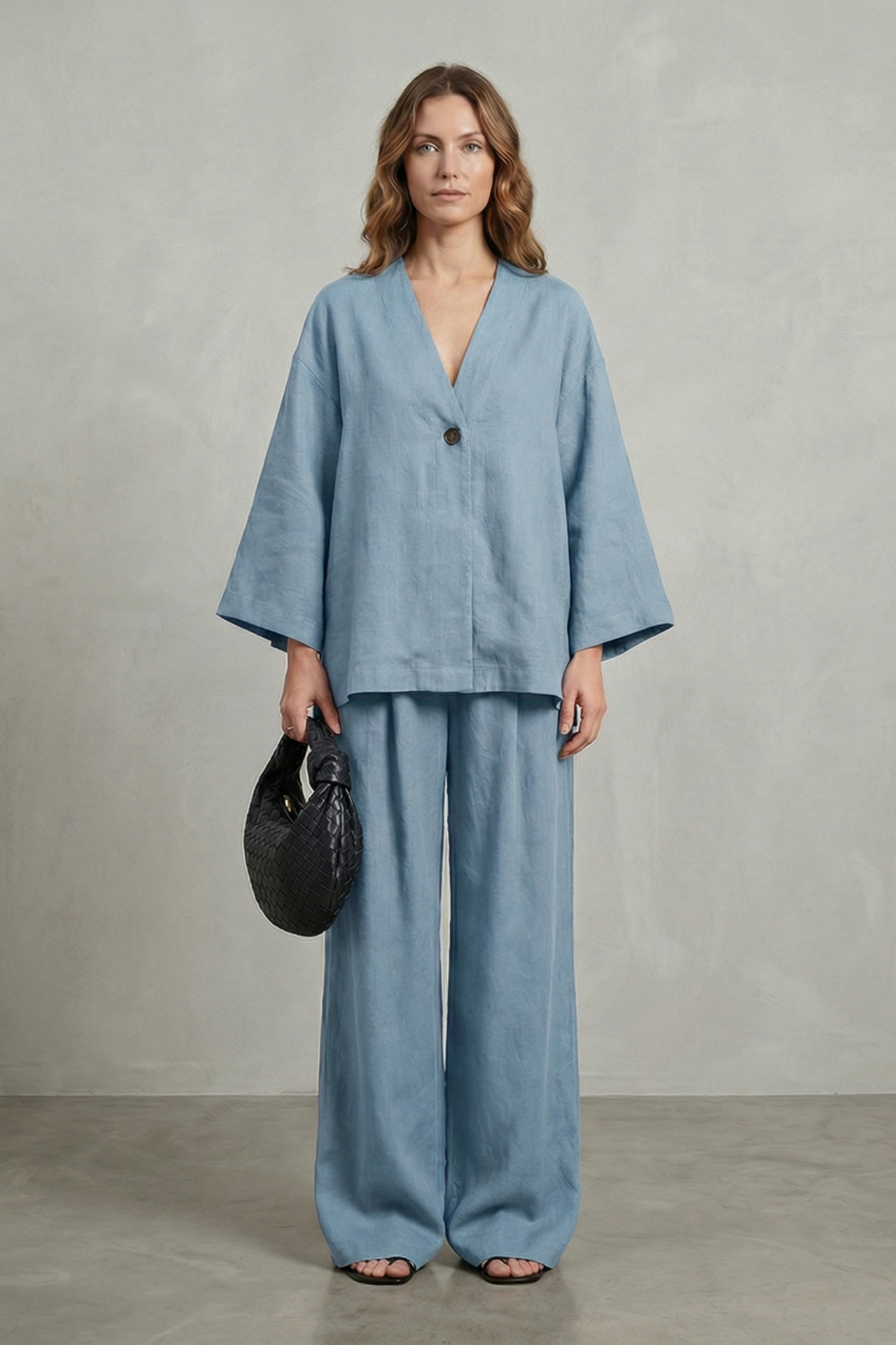 Black colorway of the wrap V-neck top and wide-leg pants set, full-length view