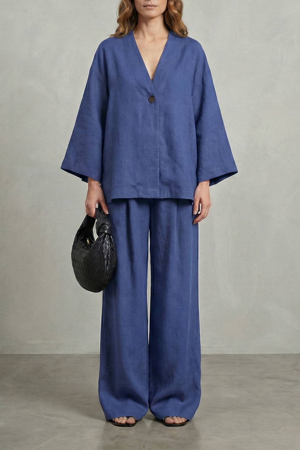 Seated view of the wrap V-neck top and wide-leg pants two-piece set