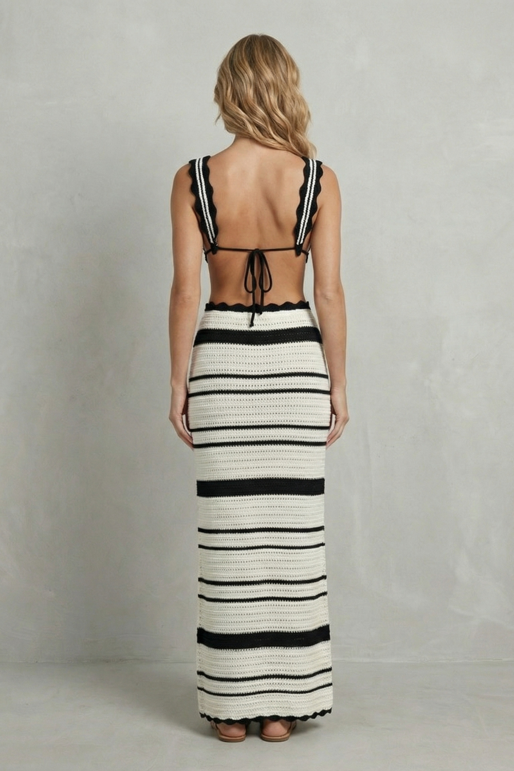Detail close-up of the deep V neckline and scalloped crochet trim