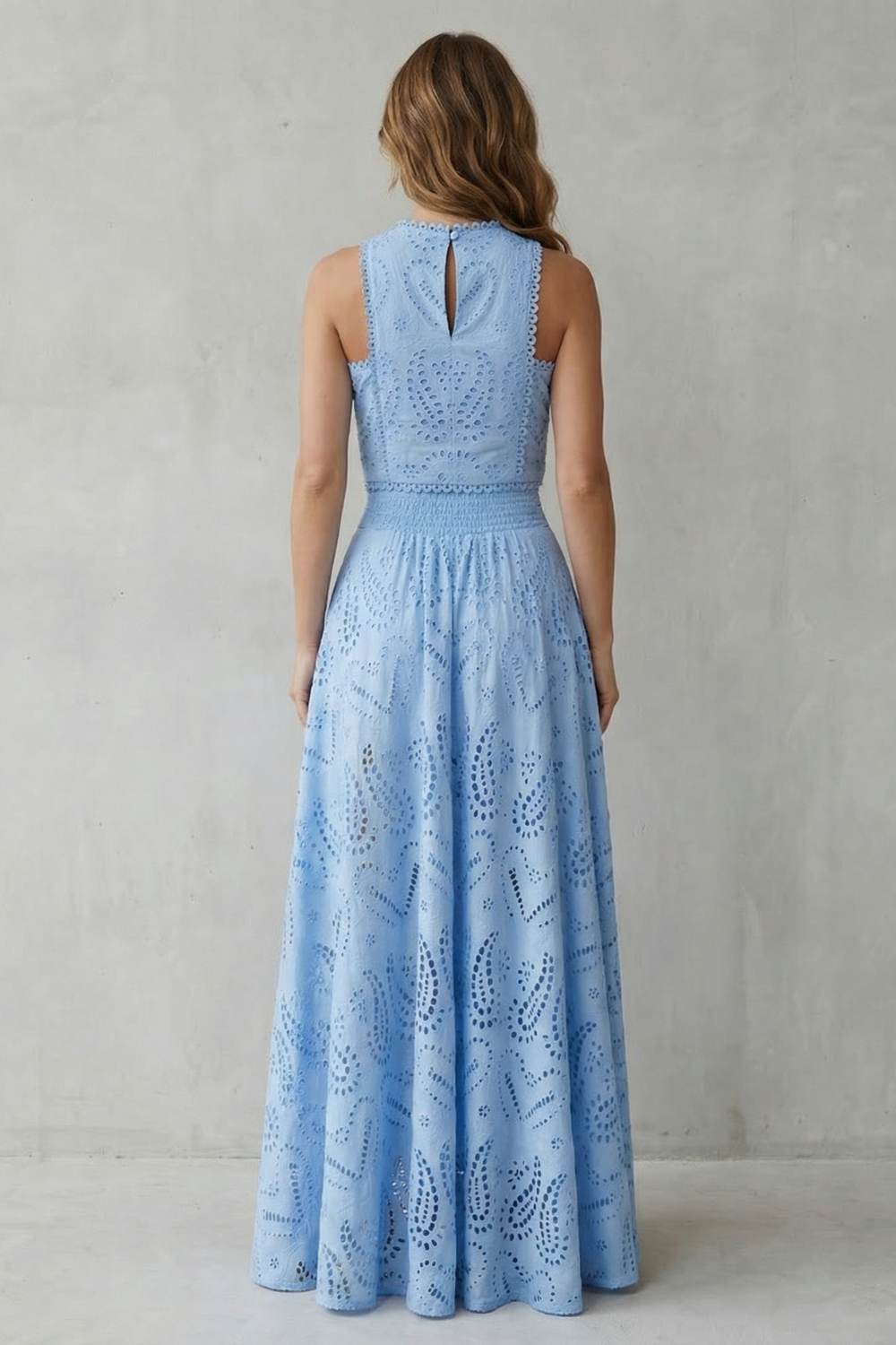 Detail close-up of the embroidered lace fabric and cropped hem