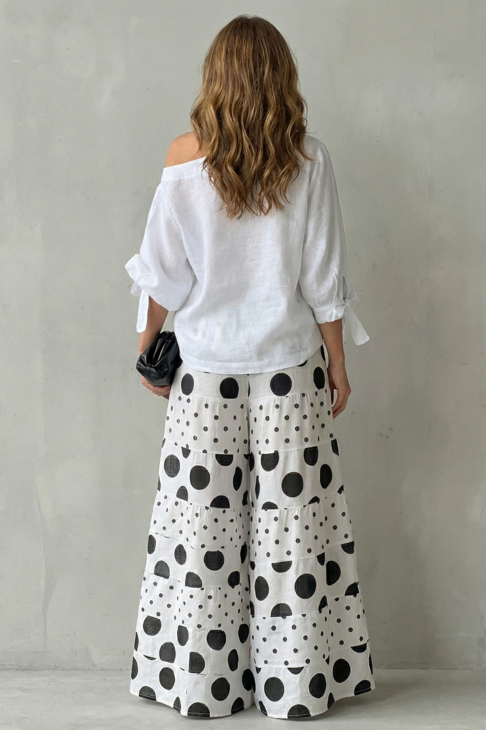 Detail close-up of the tie cuffs on the off-shoulder polka dot top