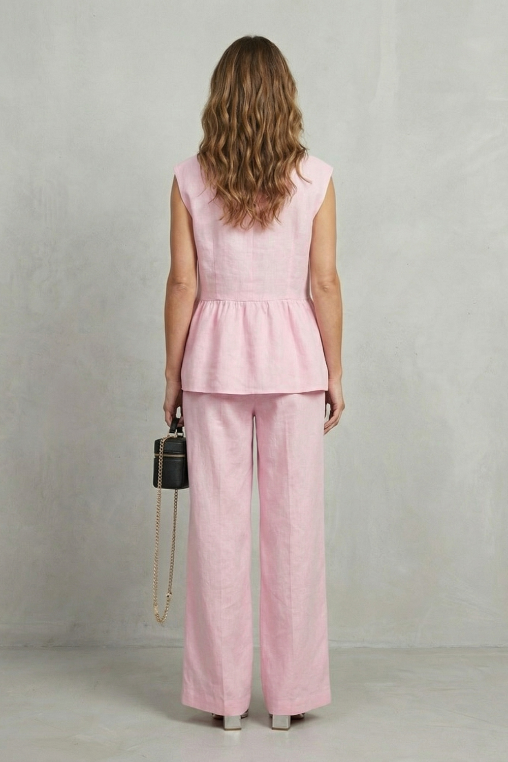 Detail close-up of the soft ruffle hem on the sleeveless top