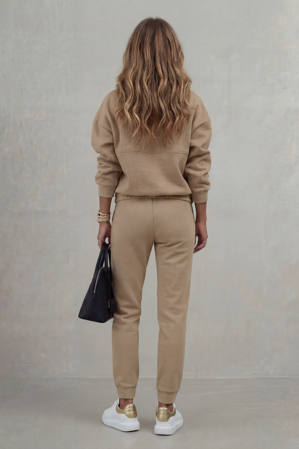 Detail close-up of the asymmetric waist drape and pleated detailing