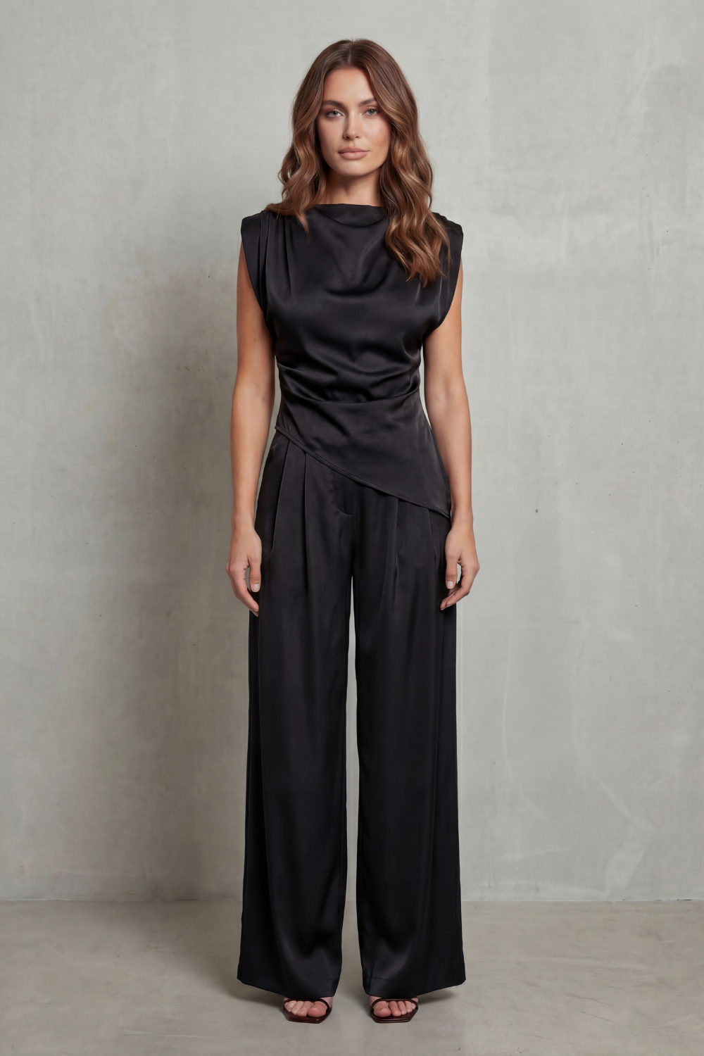 Draped-waist set styled with heels and a mini handbag for evening