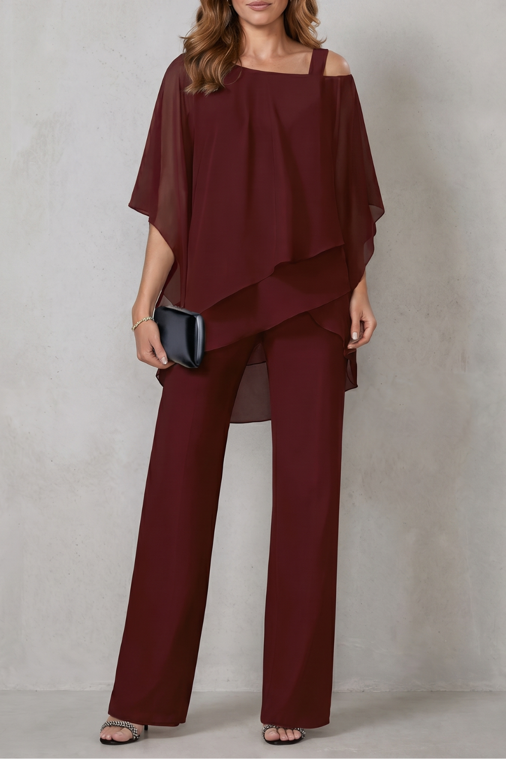 Draped two-piece set styled with black heels and a structured clutch