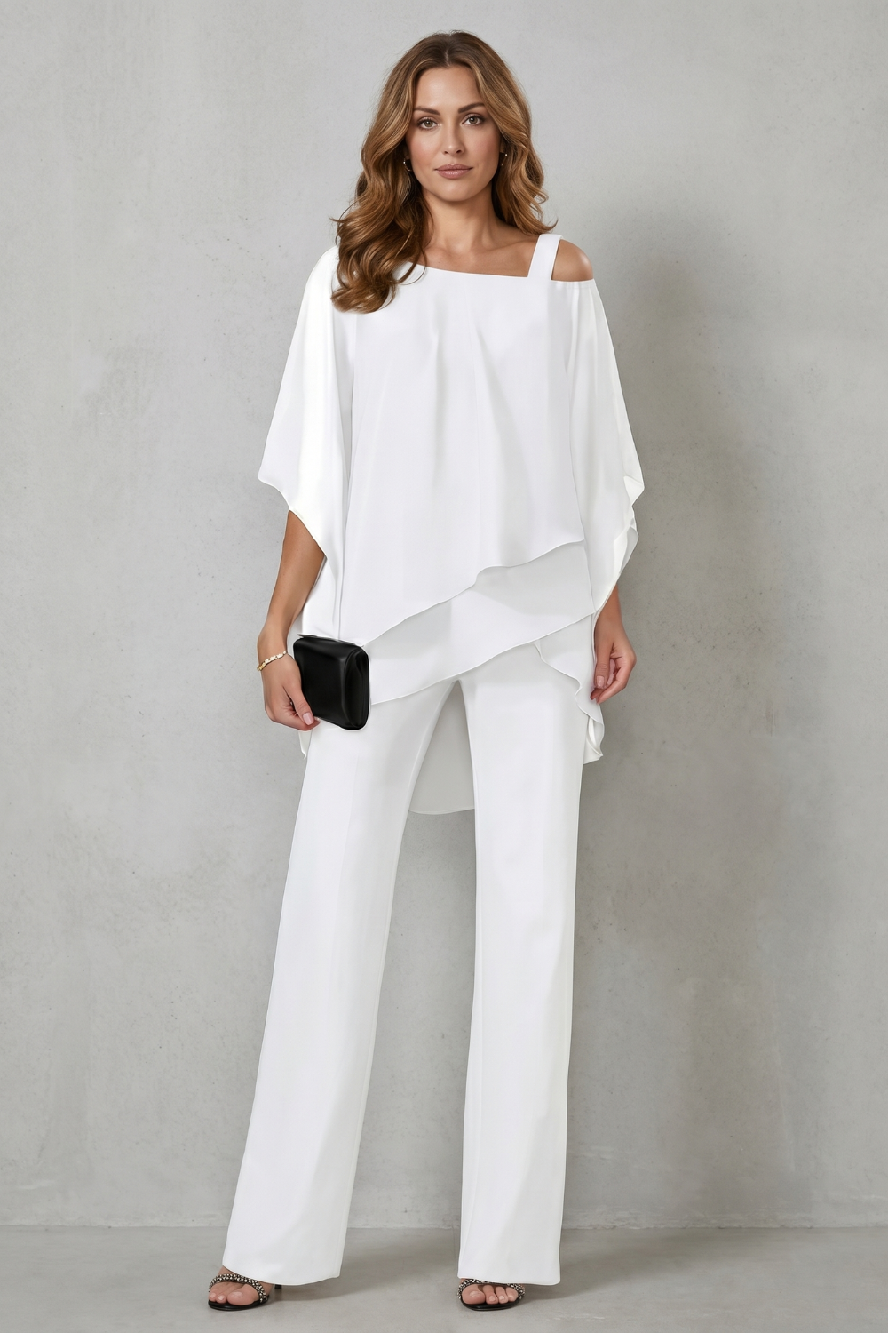 Side view of the layered draped top and relaxed wide-leg pants