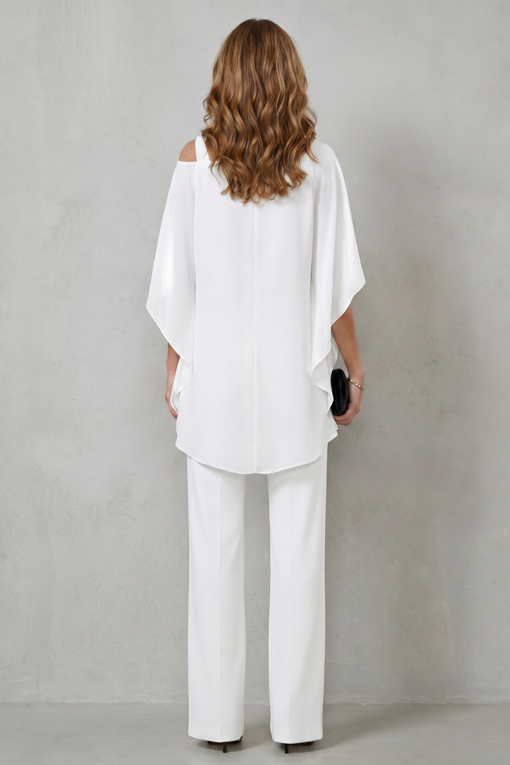 Detail close-up of the asymmetric neckline on the draped top