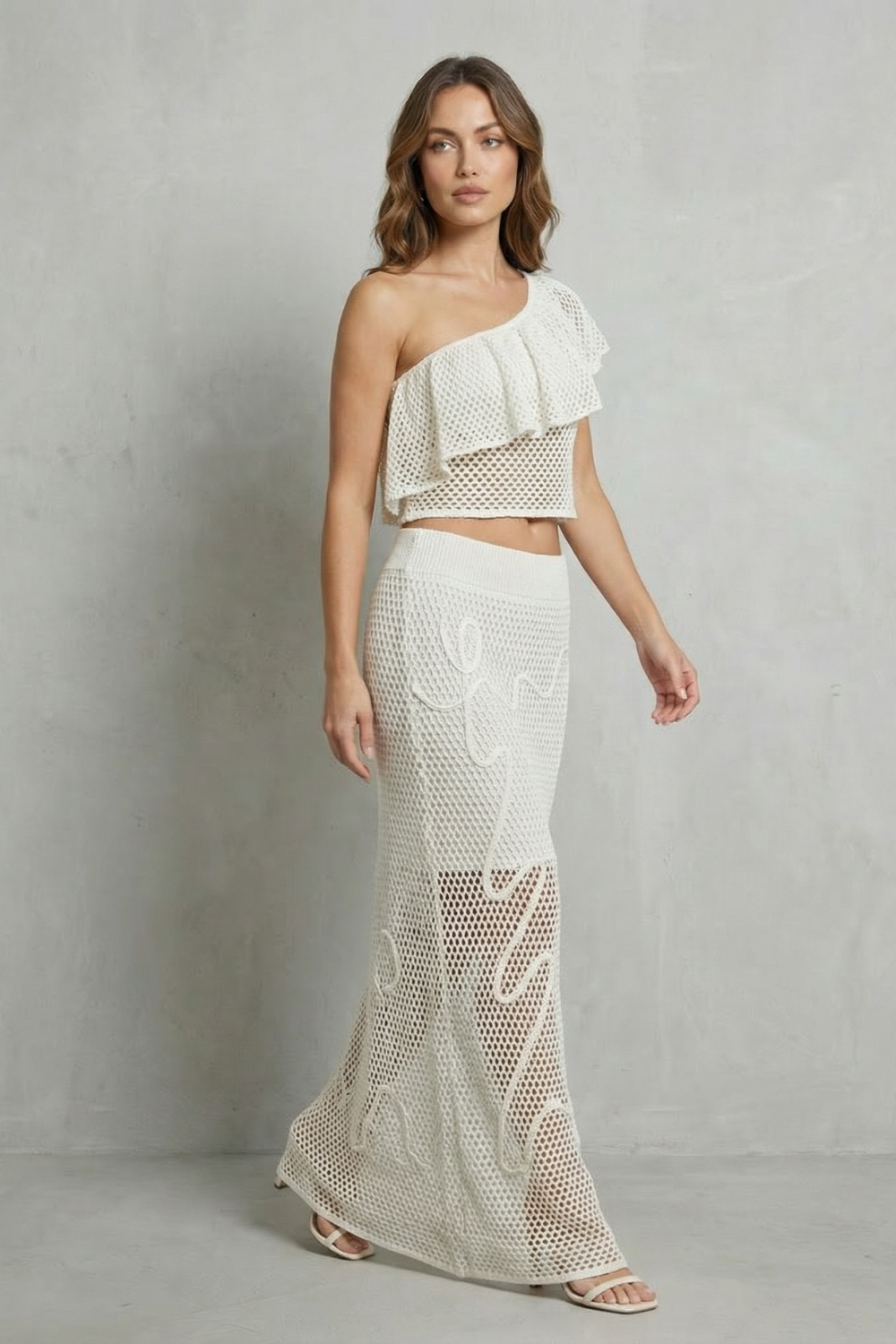 Back view of the one-shoulder knit top and matching skirt