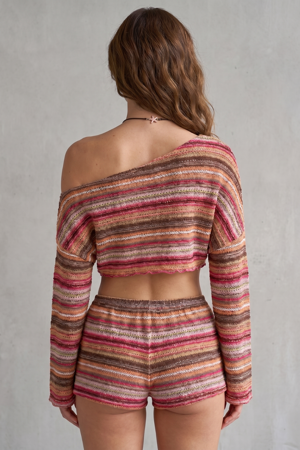 Detail close-up of the asymmetrical off-shoulder neckline