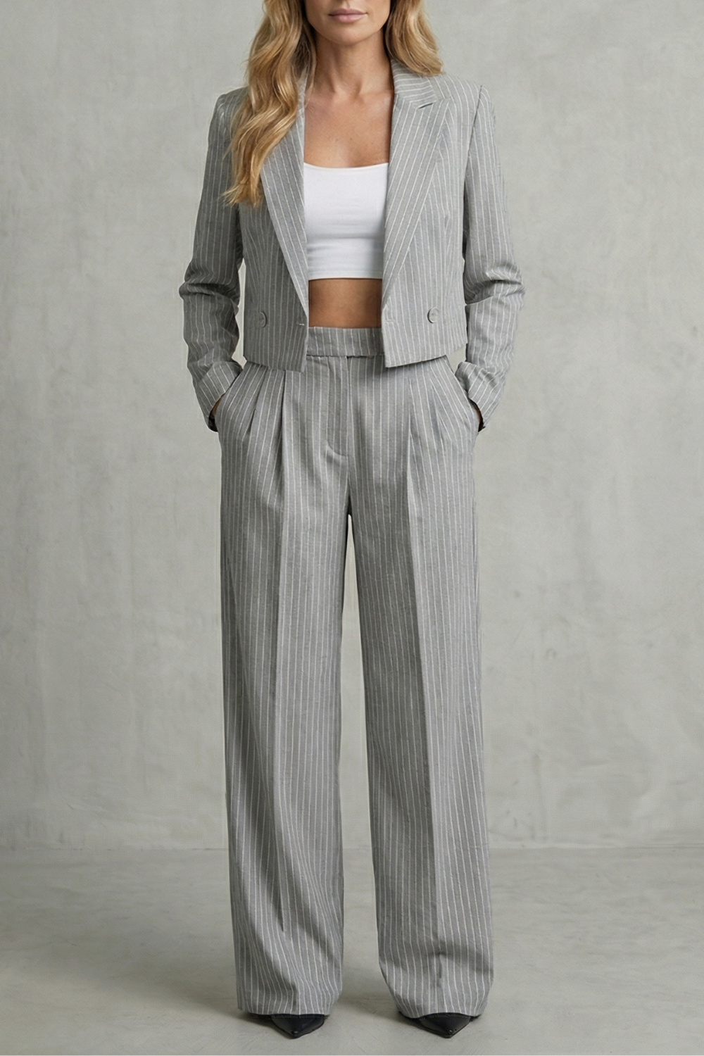 Close-up of the cropped blazer hem and high-rise pant waistband