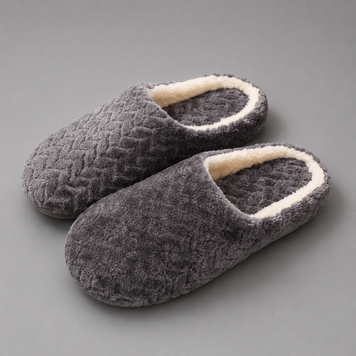 Unisex plush house slippers with a soft cloth upper, cozy lining, open-back slip-on design, cushioned sole, and non-slip outsole.