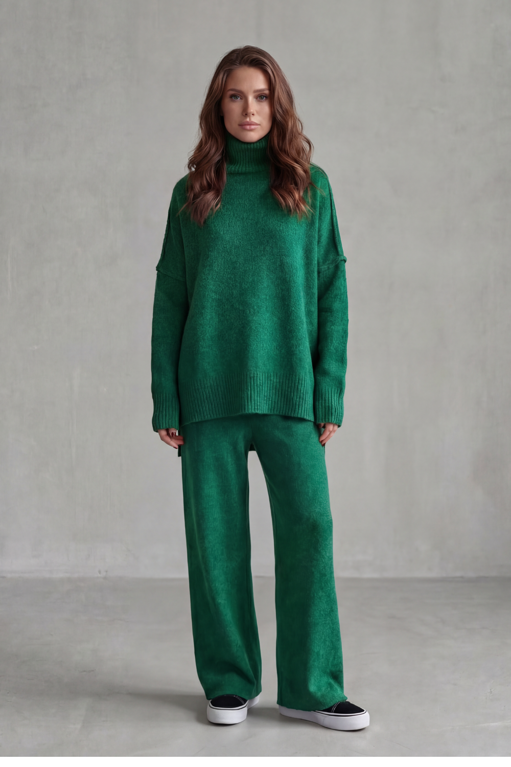 Three-quarter view showing the fluid drape of the knit pants