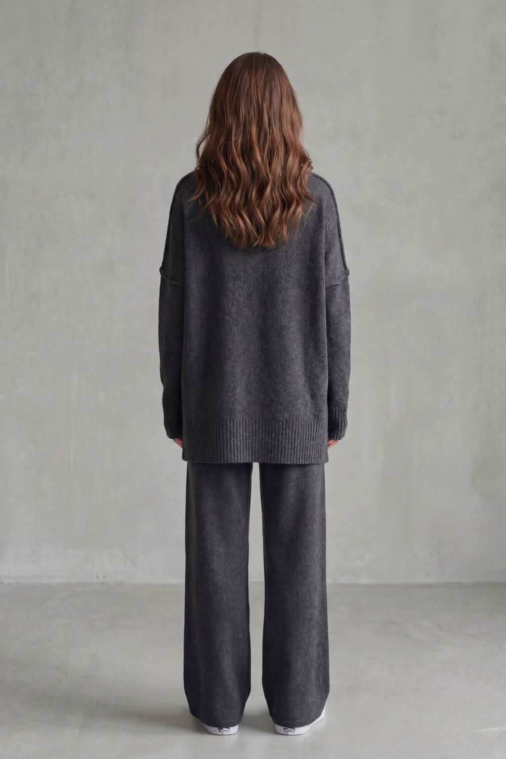 Detail close-up of the high neckline and ribbed knit texture