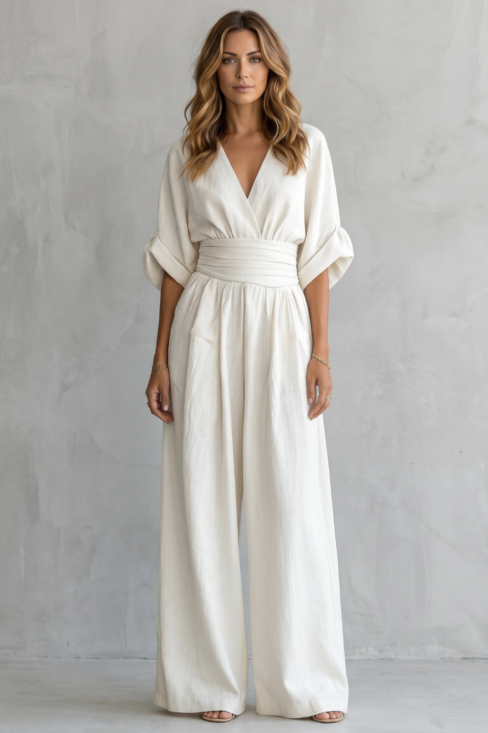 Side view of the batwing sleeve jumpsuit showing its fluid drape