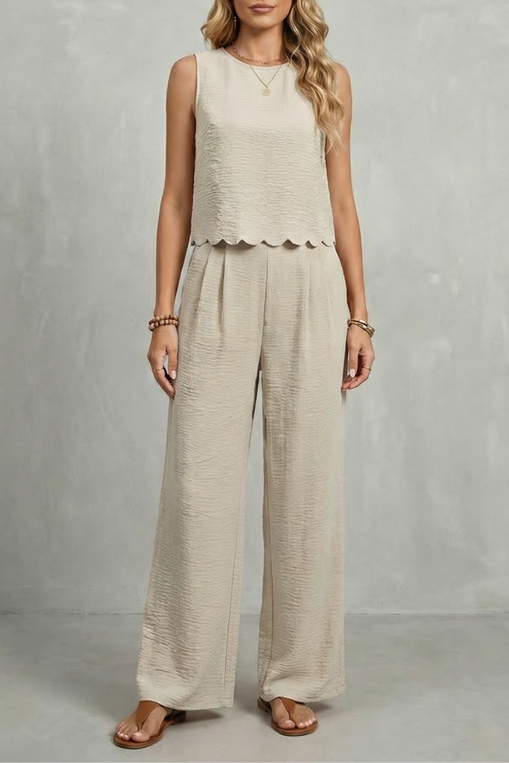 Navy colorway of the open-back bow top and wide-leg pants set, full-length view