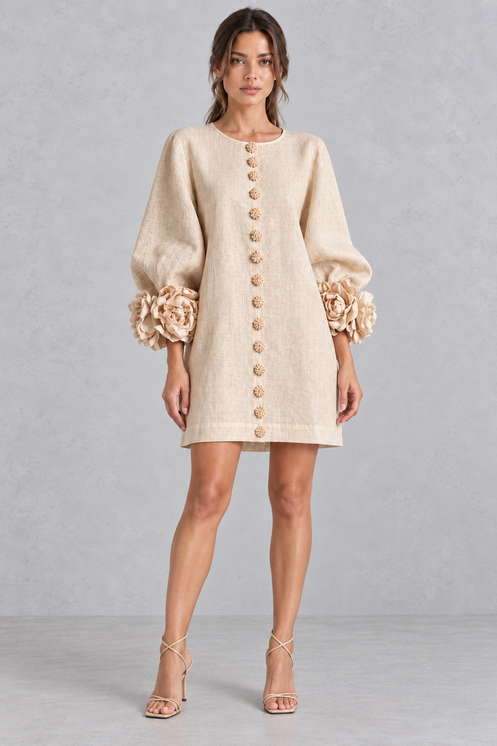 Model styling a 3D floral mini dress with ankle boots for a fall weekend outing.