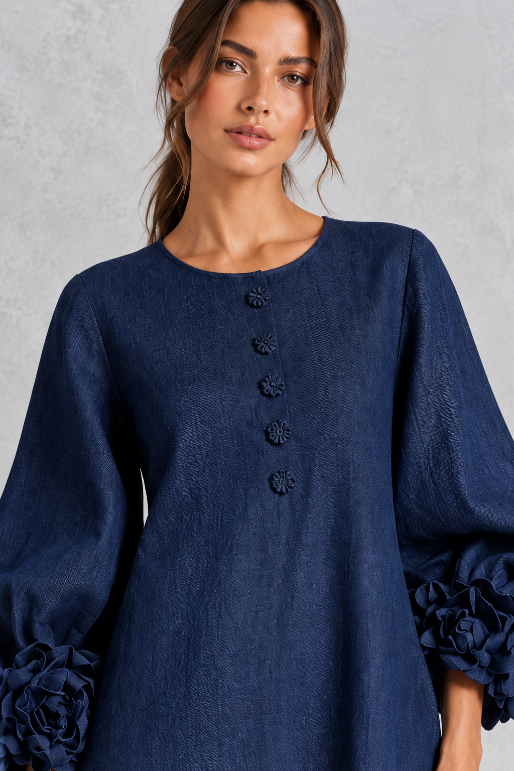 Detail of textured 3D floral appliques on a women's long sleeve maxi dress.