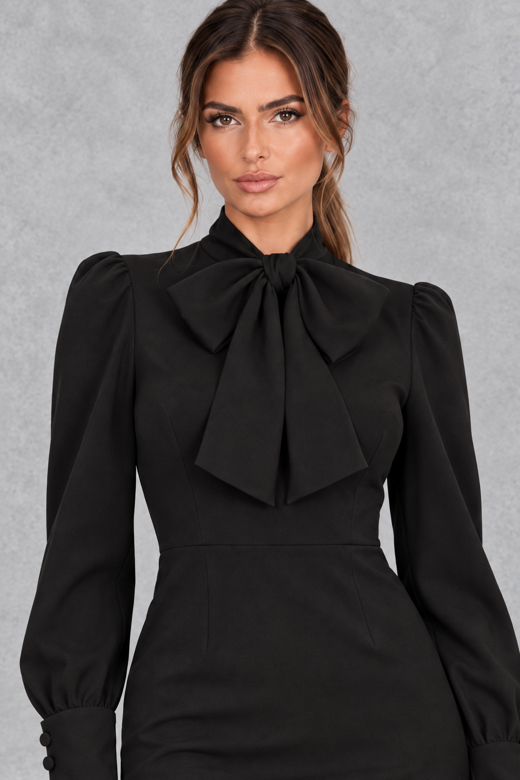 Close-up of the statement bow neckline on a women's long sleeve midi dress.