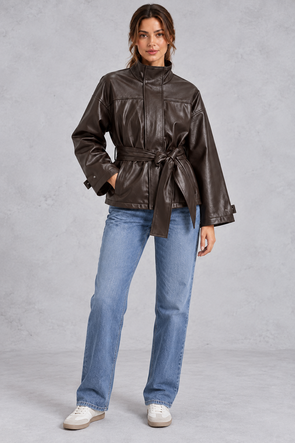 Brown faux leather jacket styled with tailored pants and boots