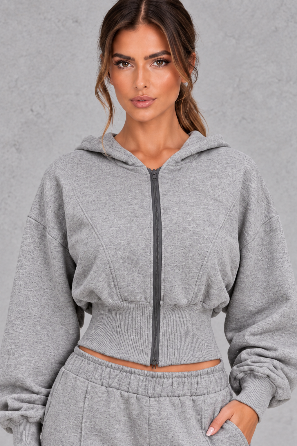 Detail close-up of the wide ribbed waistband and front zipper