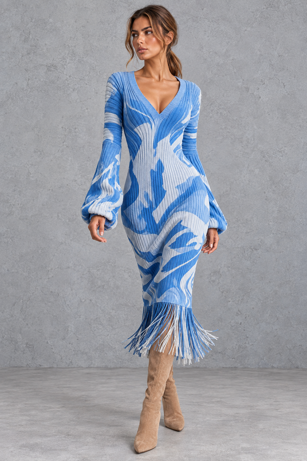 Women's fringe sweater dress layered under a longline coat