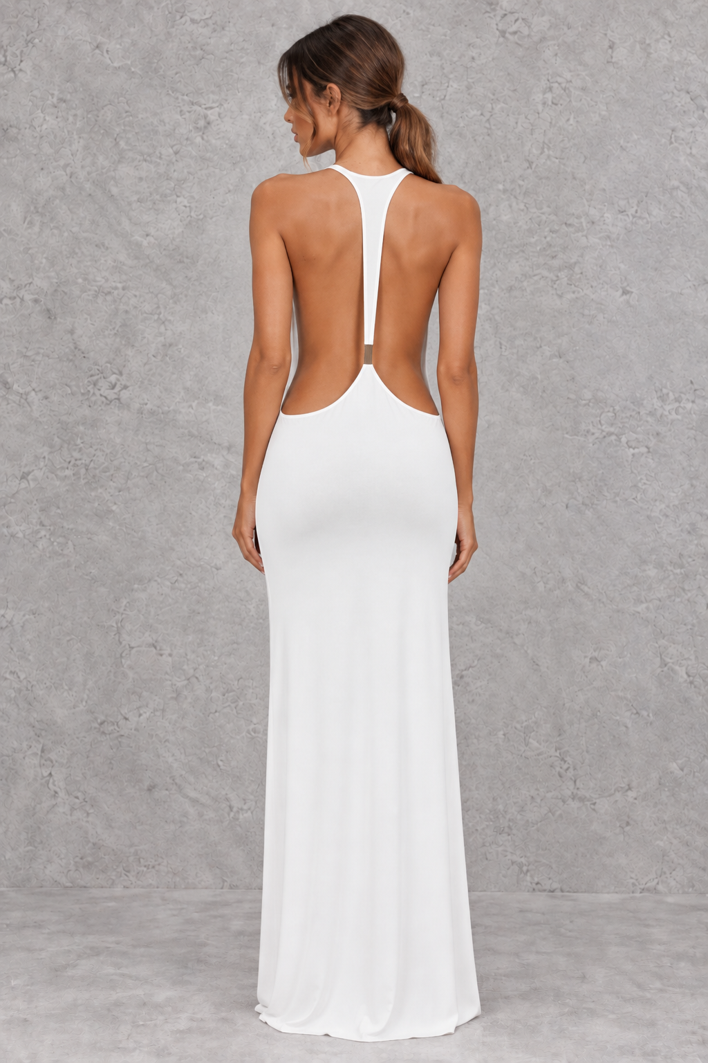 Women's strappy bodycon maxi dress styled with heels for a formal evening.