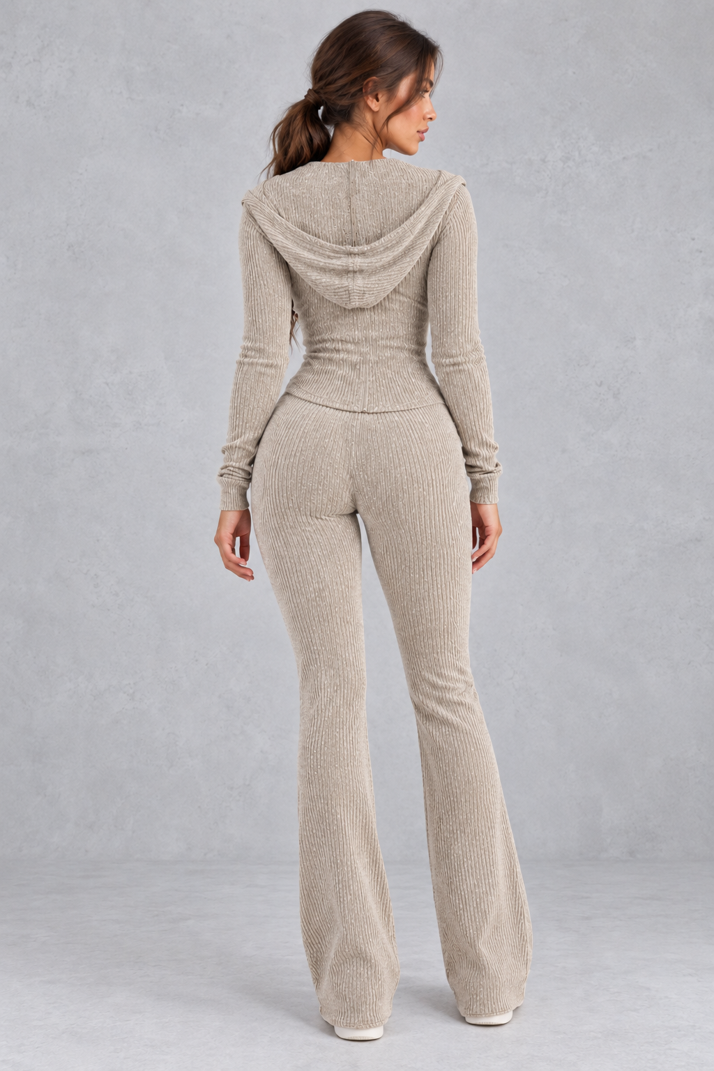 Full-length view showing the relaxed flared leg of the knit pants