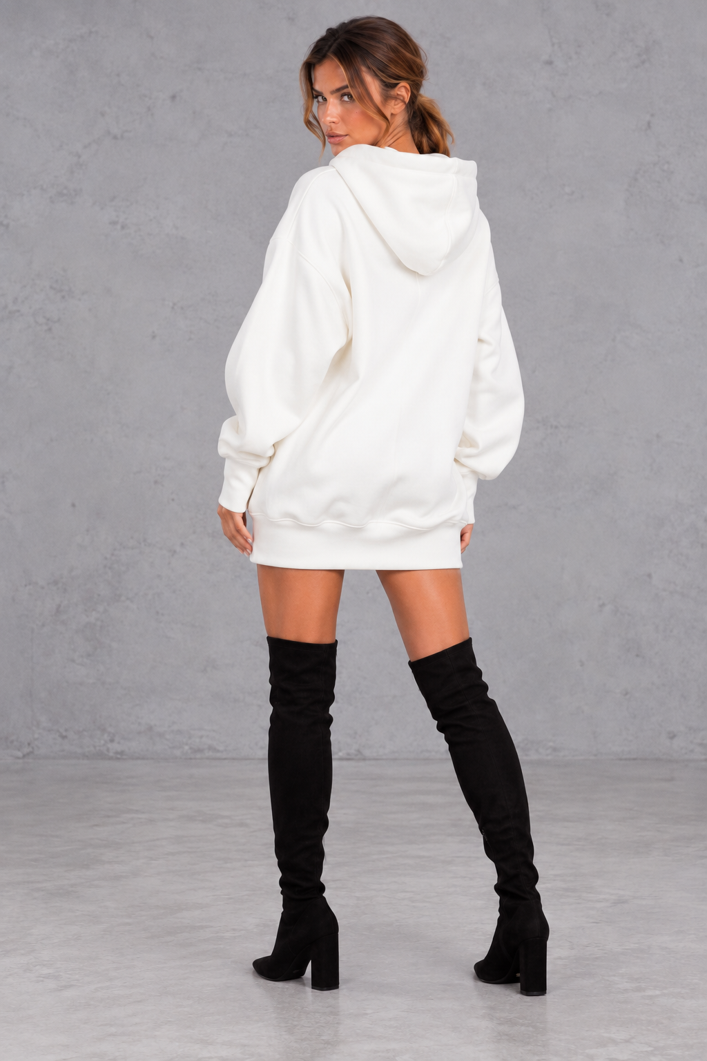 Back view of a women's slouchy oversized hoodie dress with dropped shoulders