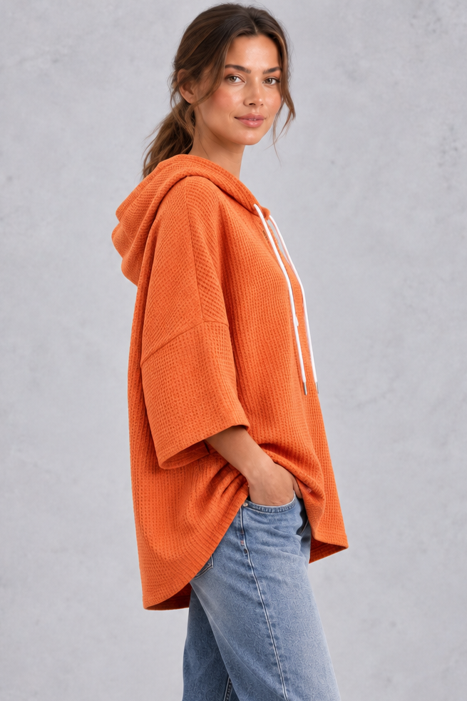 Oversized waffle knit hoodie with wide 3/4 sleeves, styled look