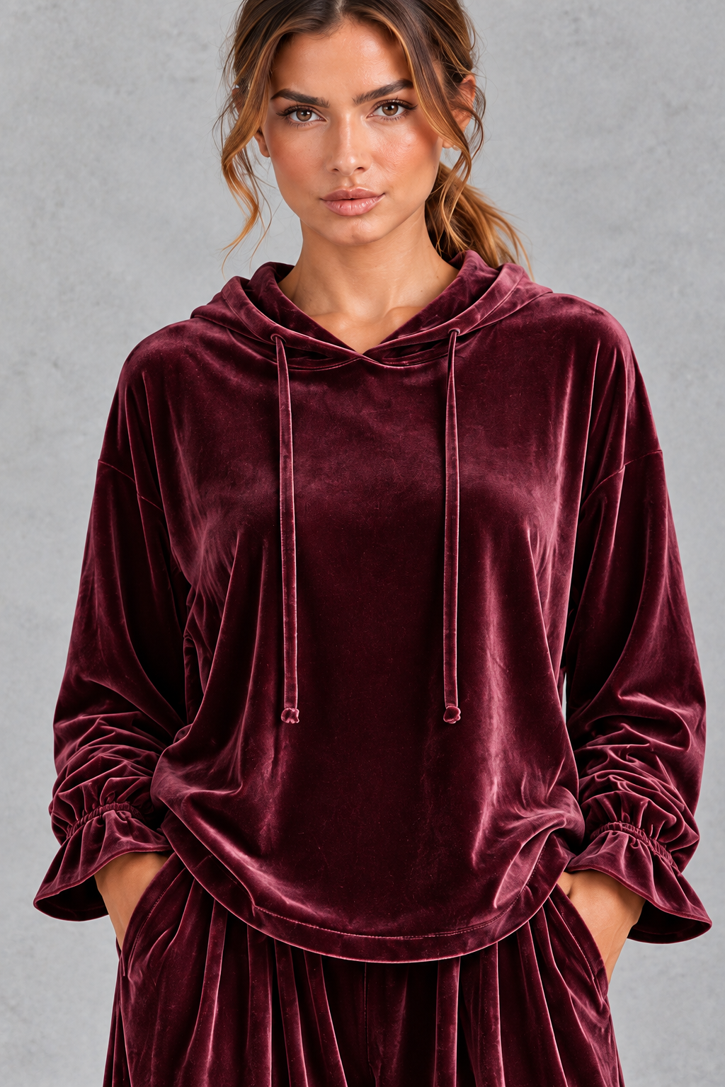 Back view of the relaxed velvet hoodie with curved hem