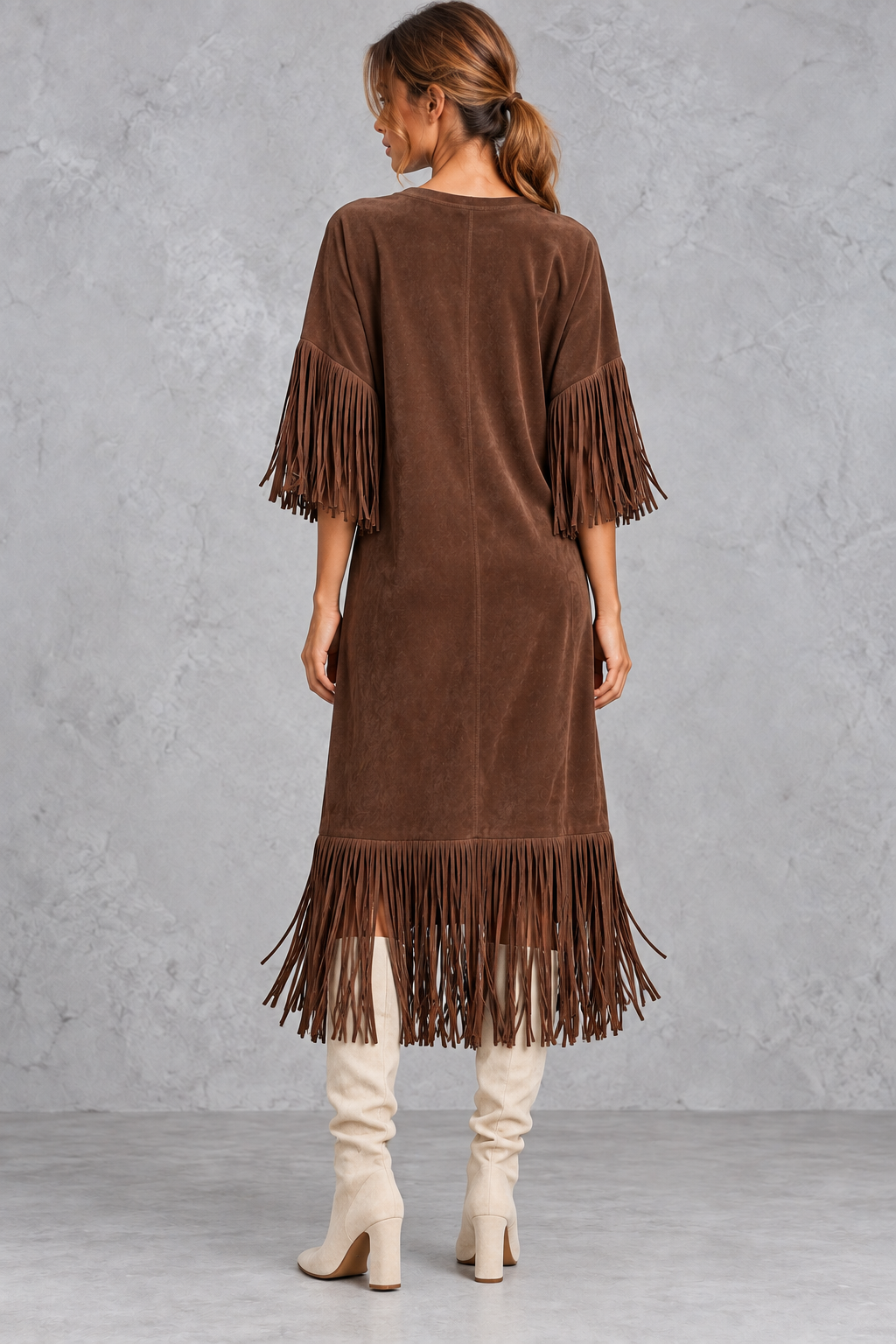 Back view of a women's A-line faux suede midi dress with fringe hem