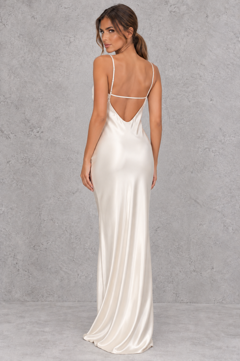 Close-up of delicate lace patchwork on a smooth satin-look maxi dress.