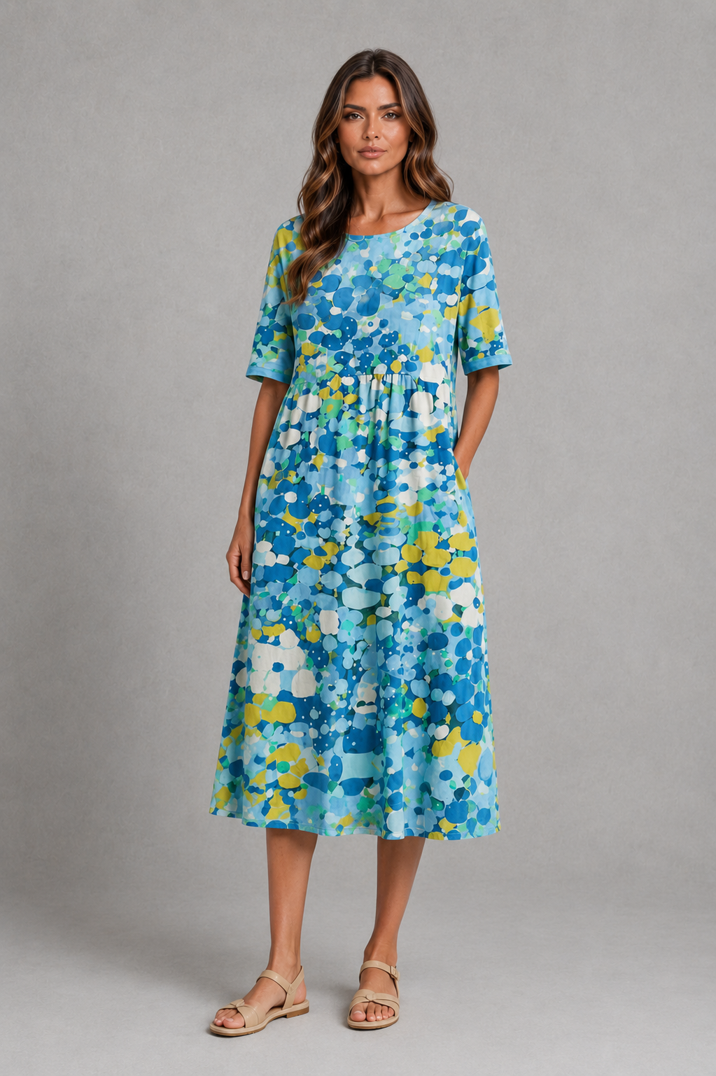 Women’s abstract print midi dress with round neckline, short sleeves, gathered waist, side pockets and a relaxed A-line silhouette.