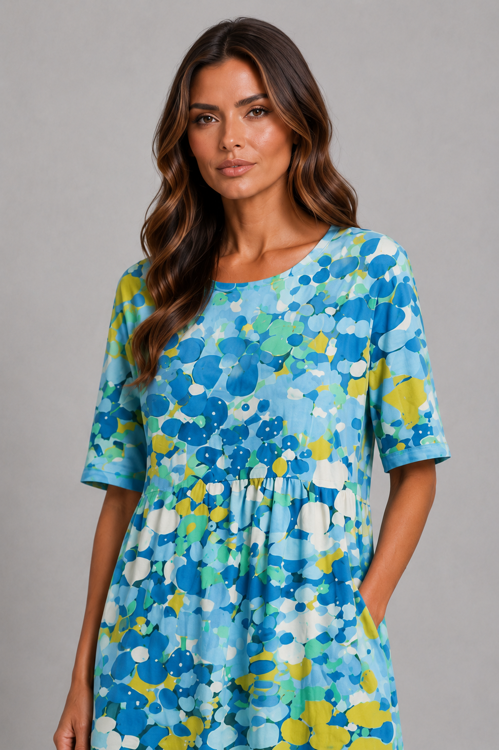 Women’s abstract print midi dress with round neckline, short sleeves, gathered waist, side pockets and a relaxed A-line silhouette.