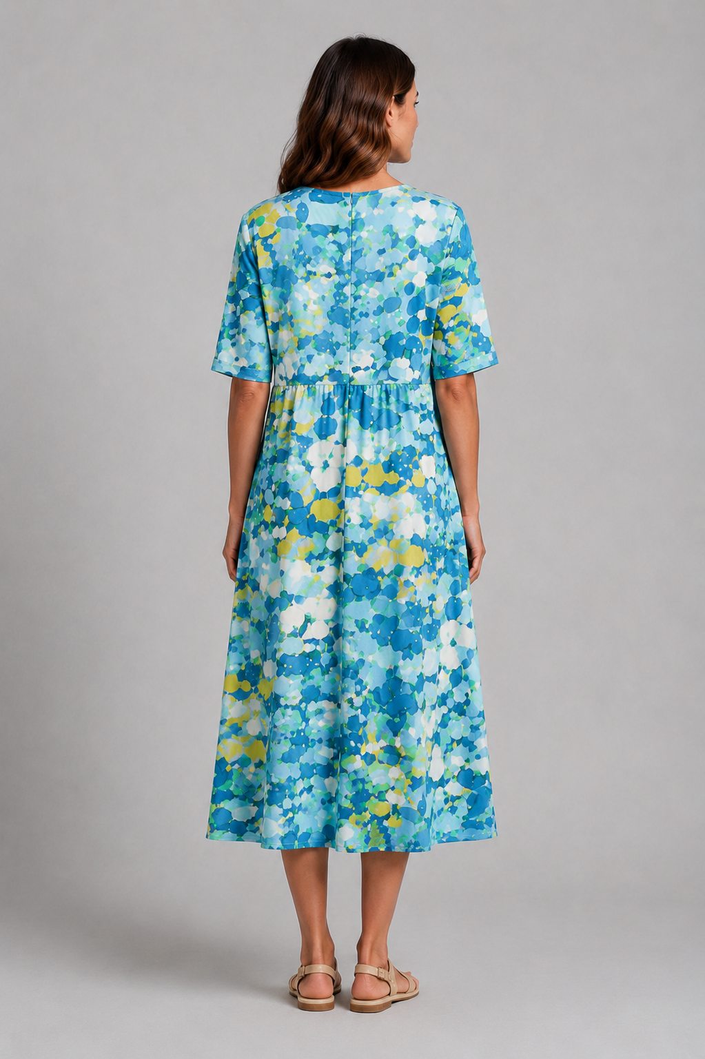 Women’s abstract print midi dress with round neckline, short sleeves, gathered waist, side pockets and a relaxed A-line silhouette.
