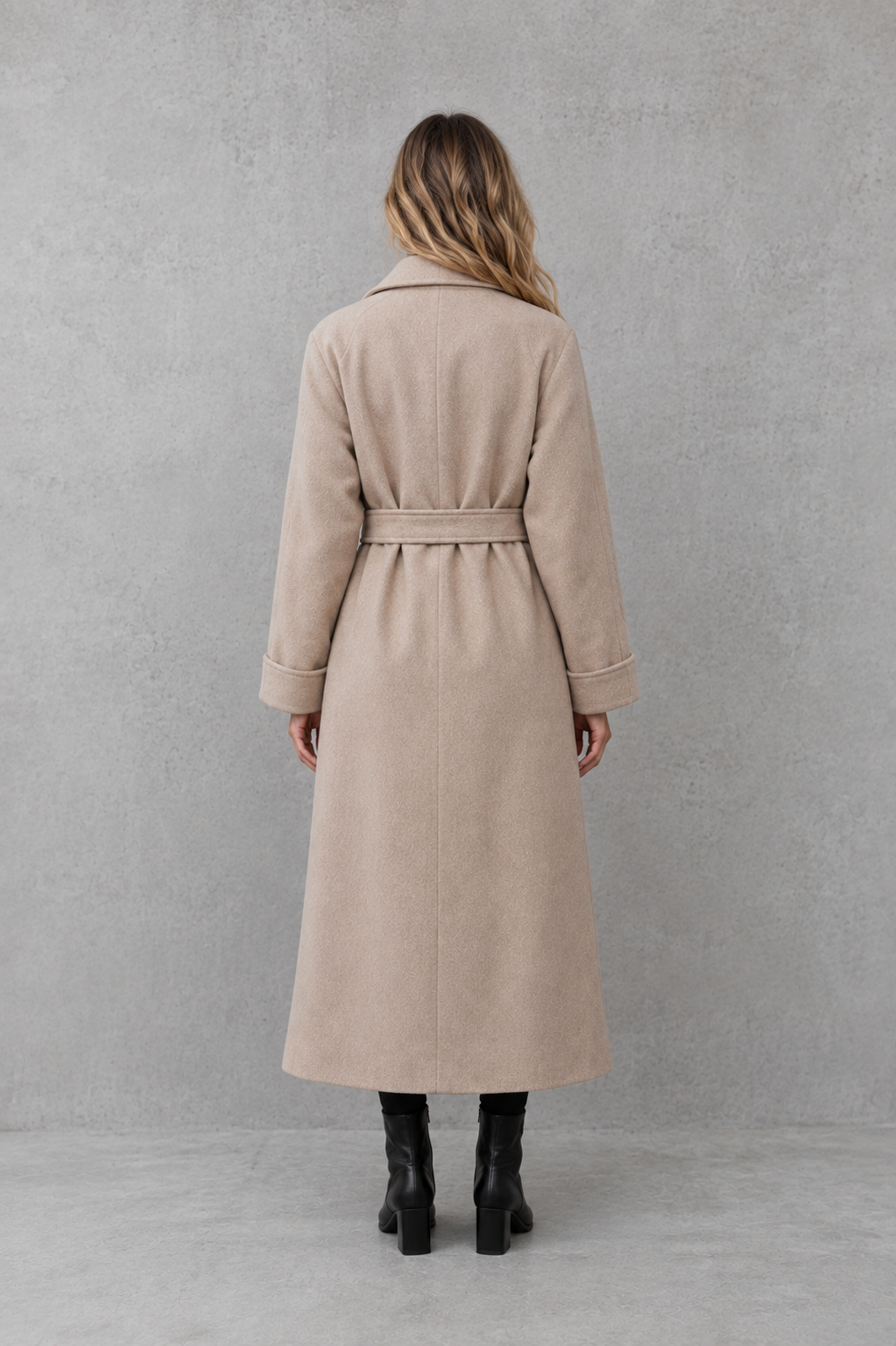 Women’s belted longline wrap coat with a classic lapel collar, adjustable waist tie, straight-cut silhouette, and structured tailored finish.