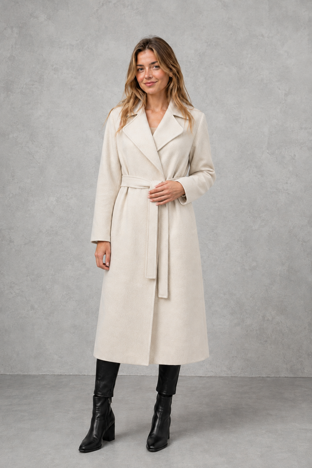 Women’s belted longline wrap coat with a classic lapel collar, adjustable waist tie, straight-cut silhouette, and structured tailored finish.