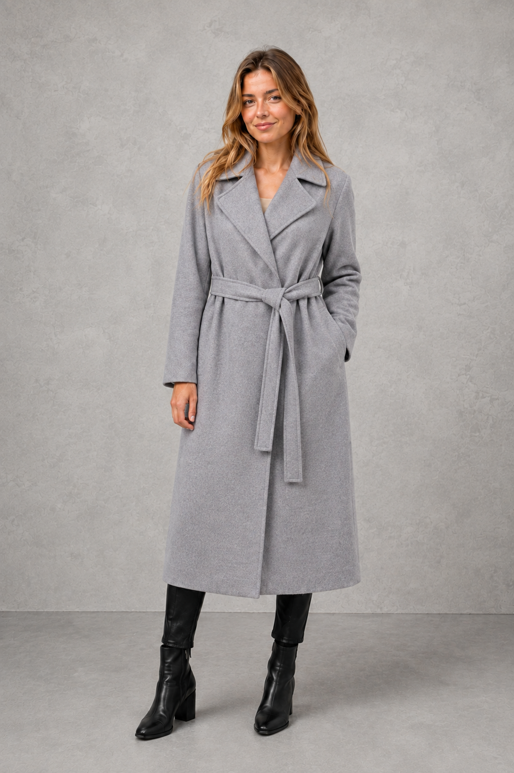 Women’s belted longline wrap coat with a classic lapel collar, adjustable waist tie, straight-cut silhouette, and structured tailored finish.