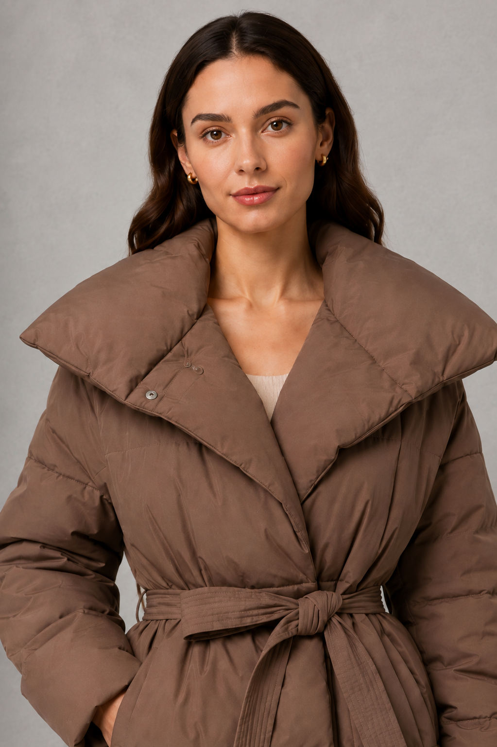 Women’s belted quilted puffer jacket with soft insulated padding, adjustable waist belt, full-length front zipper, and a flattering regular-fit silhouette.