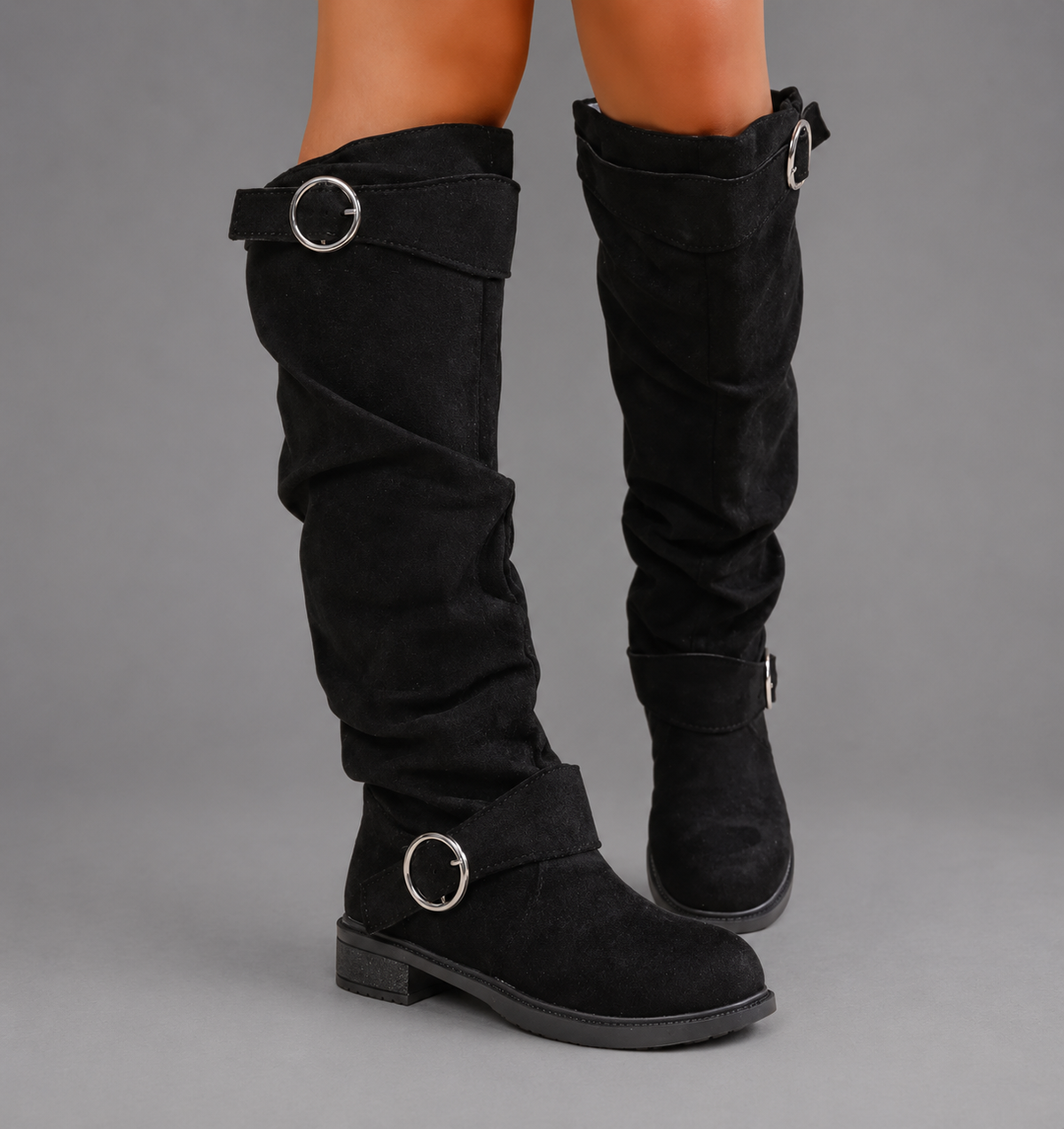 Women’s black slouch mid-calf boots with decorative buckle accents, relaxed shaft, slip-on design, soft textile lining, and durable rubber outsole.