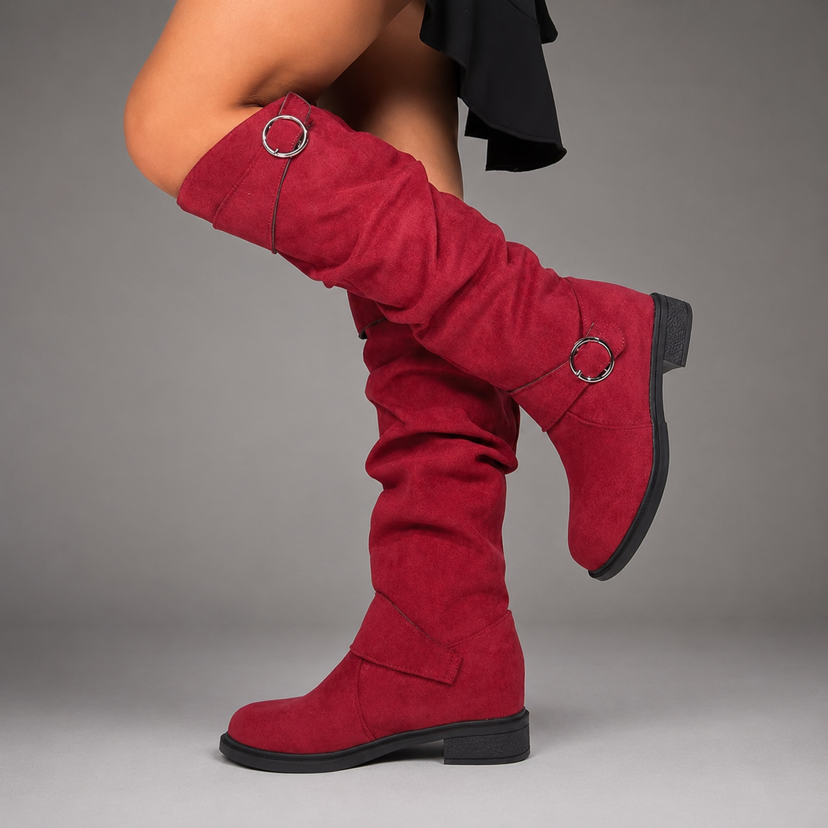 Women’s black slouch mid-calf boots with decorative buckle accents, relaxed shaft, slip-on design, soft textile lining, and durable rubber outsole.