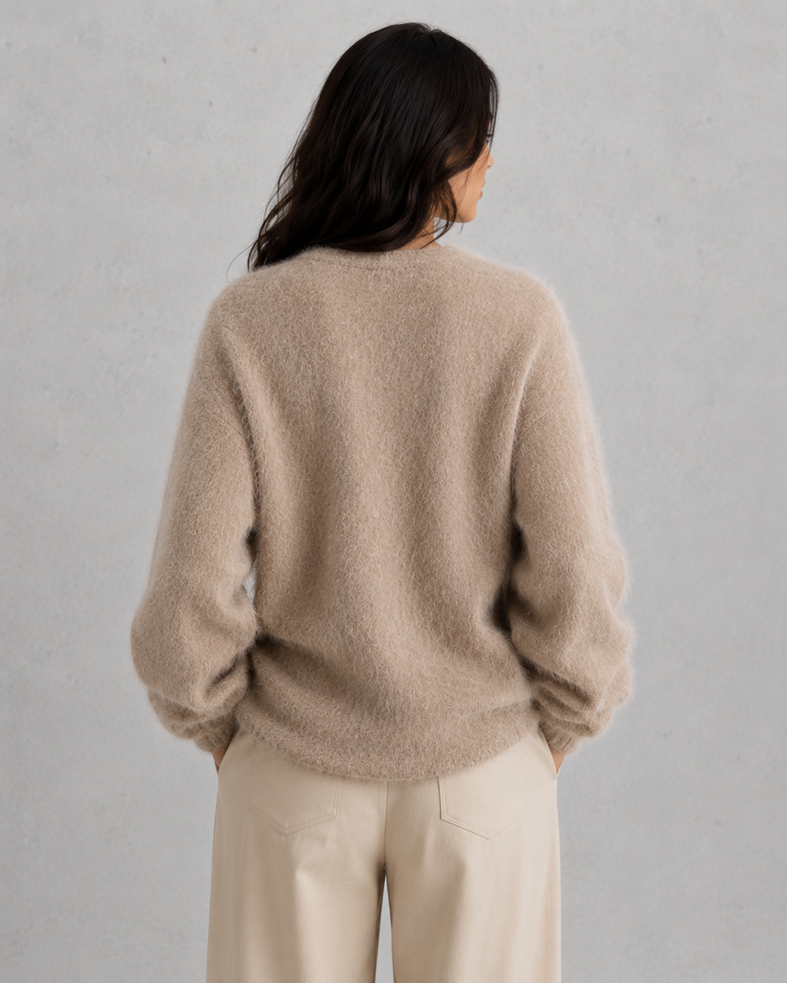 Woman wearing a soft button-front knit cardigan in a relaxed fit, styled for elegant autumn and winter layering.